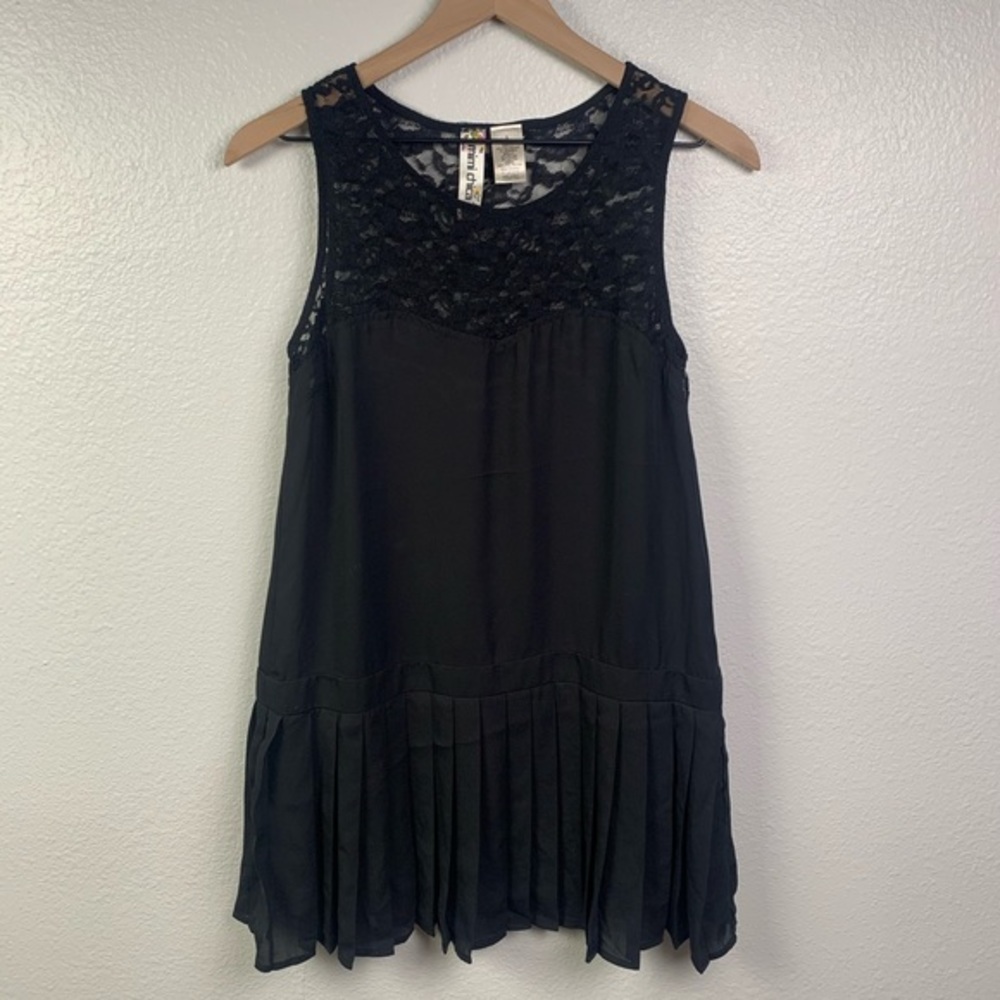 Black lace top dress with a drop waist and pleats